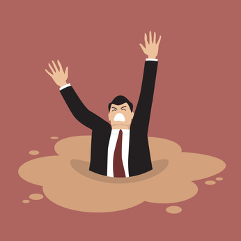 Businessman sinking in a puddle of quicksand. Business concept